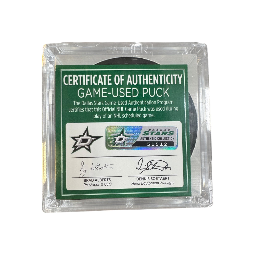 A game-used hockey puck in a clear plastic protective case with a green and white Certificate of Authenticity insert. COA #  51512
