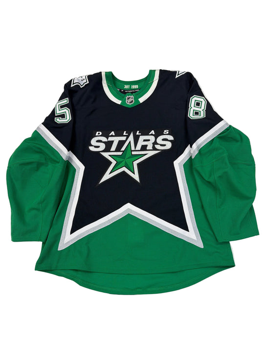 Green and black sports hoodie with star logo on a white surface