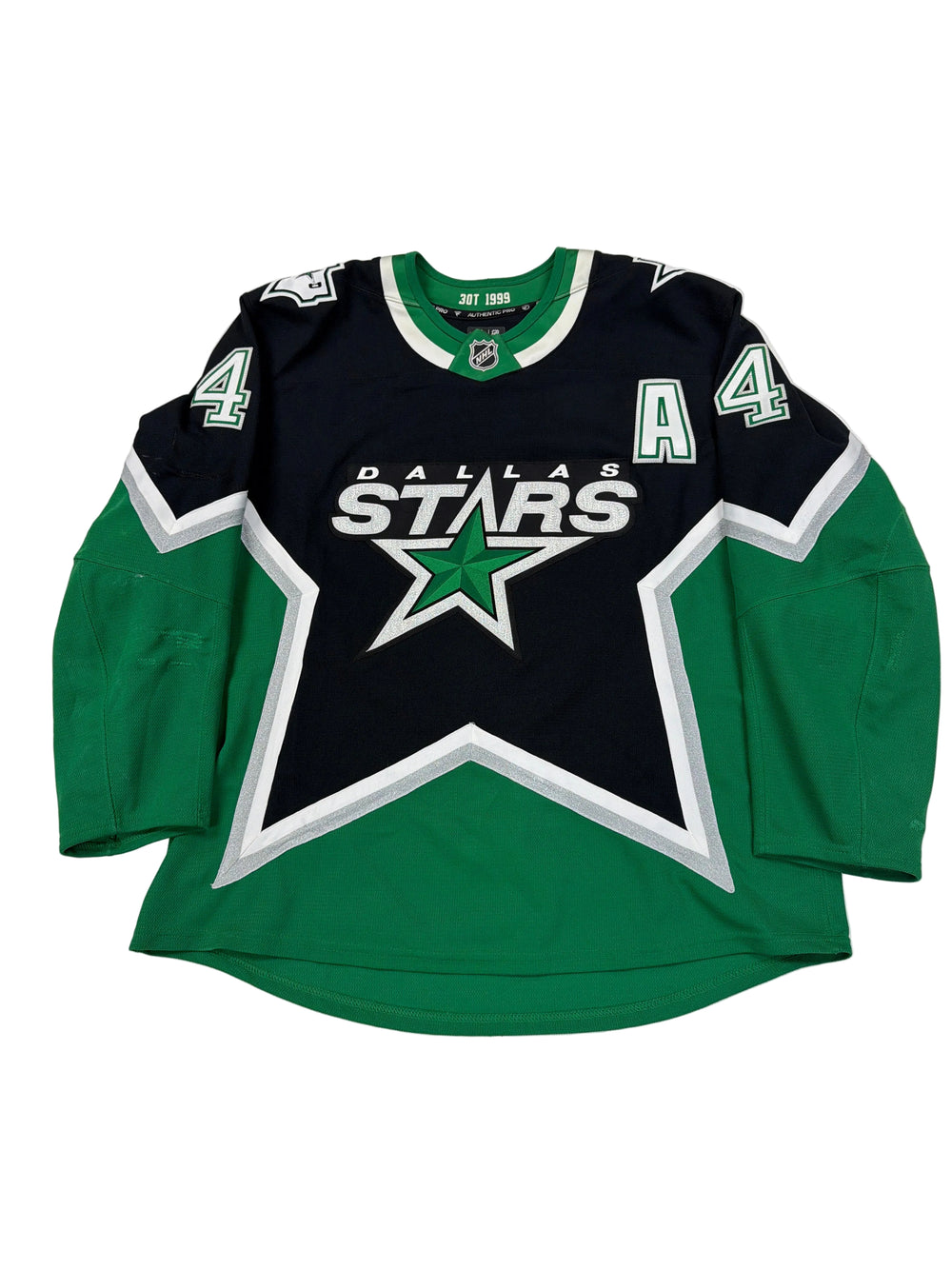 Green and black sports jersey with a star logo on a white surface