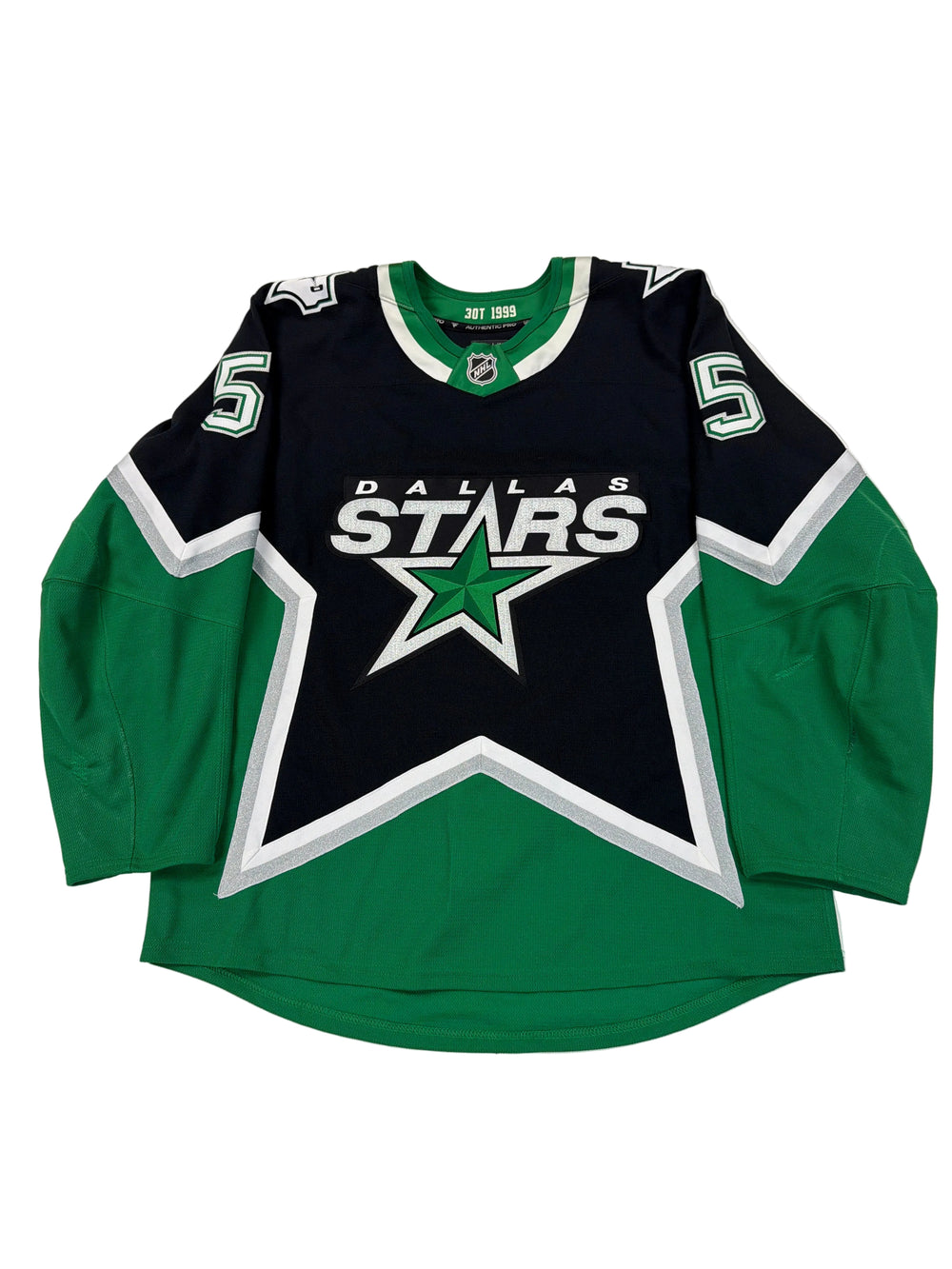 Green and black sports jersey with a star logo on a white surface
