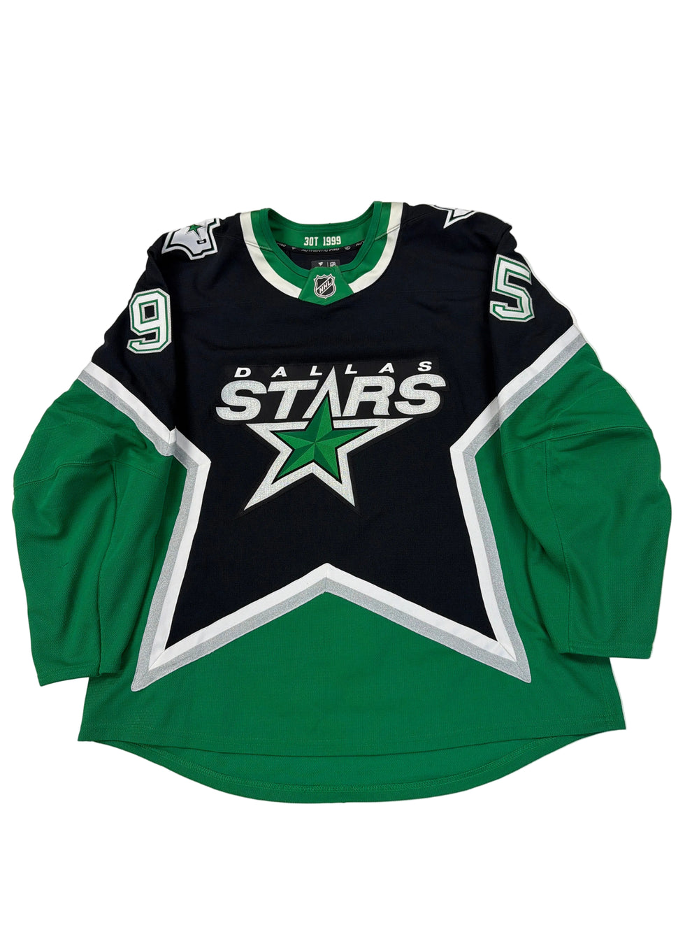 Green and black sports jersey with star logo on a white surface