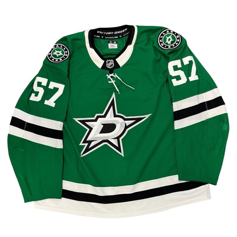 Game Worn Dallas Stars Home hockey jersey with number 57 on sleeves and Stars logo on chest with a white background