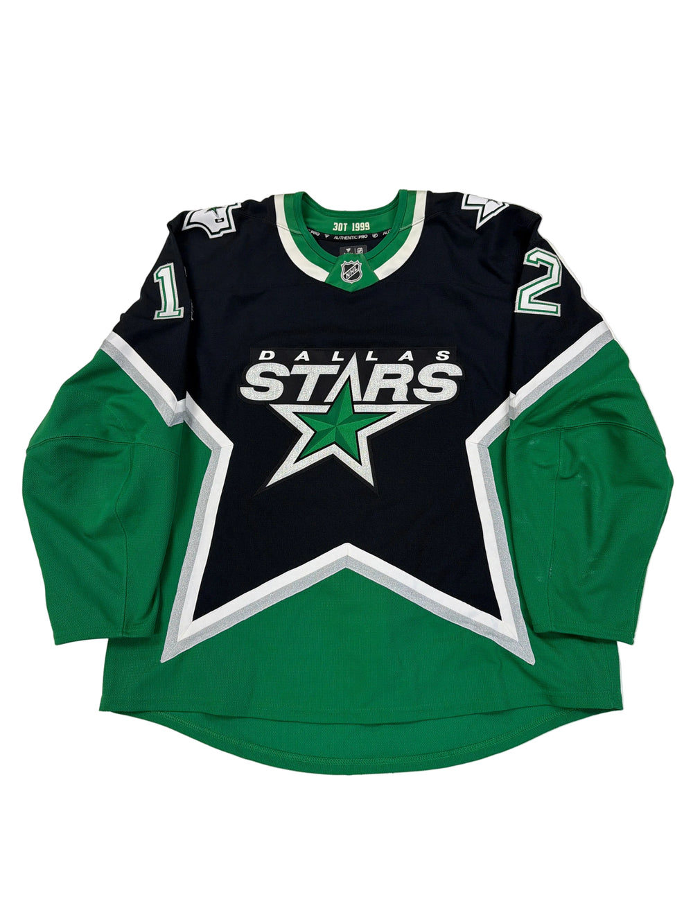 Green and black sports jersey with star design on a white surface
