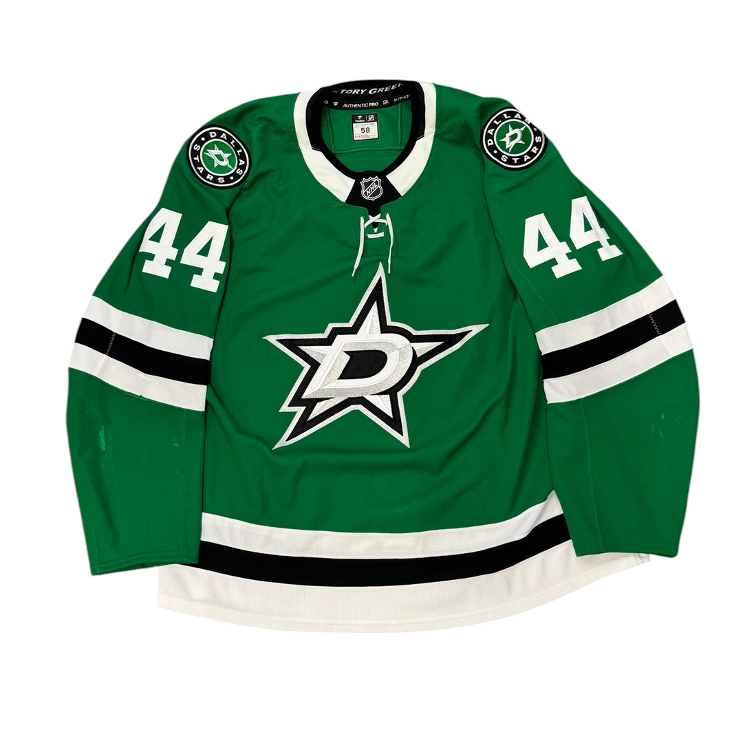 Game Worn Dallas Stars Home hockey jersey with number 44 on sleeves and Stars logo on chest with a white background