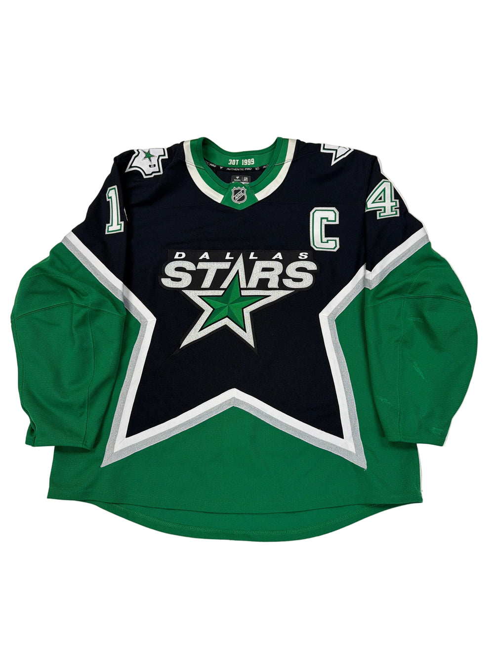 Green and black sports jersey with star design on a white surface