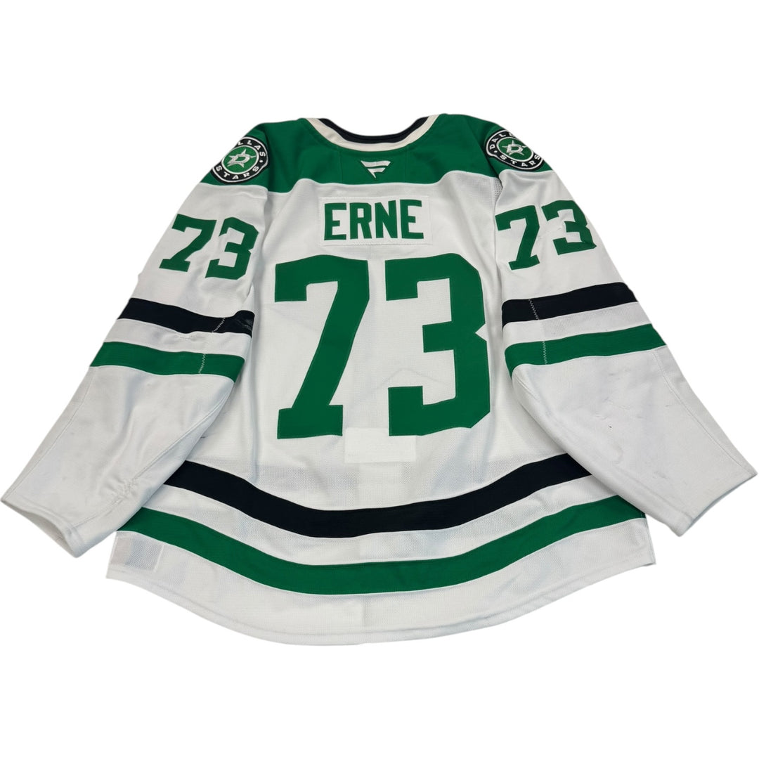 Game worn Dallas Stars away and white hockey jersey with 'Erne' and number '73'. Jersey on a white background
