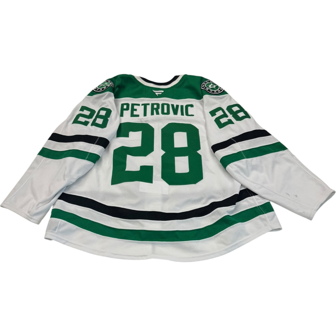 Game worn Dallas stars away jersey with number 28 and name Petrovic. Jersey on a white background