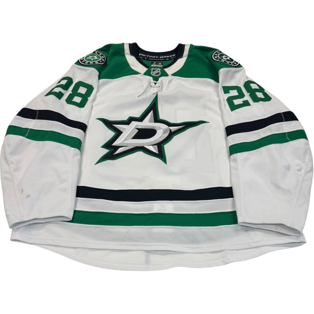 Game worn Dallas Stars Away jersey, number 28 on the sleeves with Dallas Stars logo on the chest. Hockey jersey on a white background
