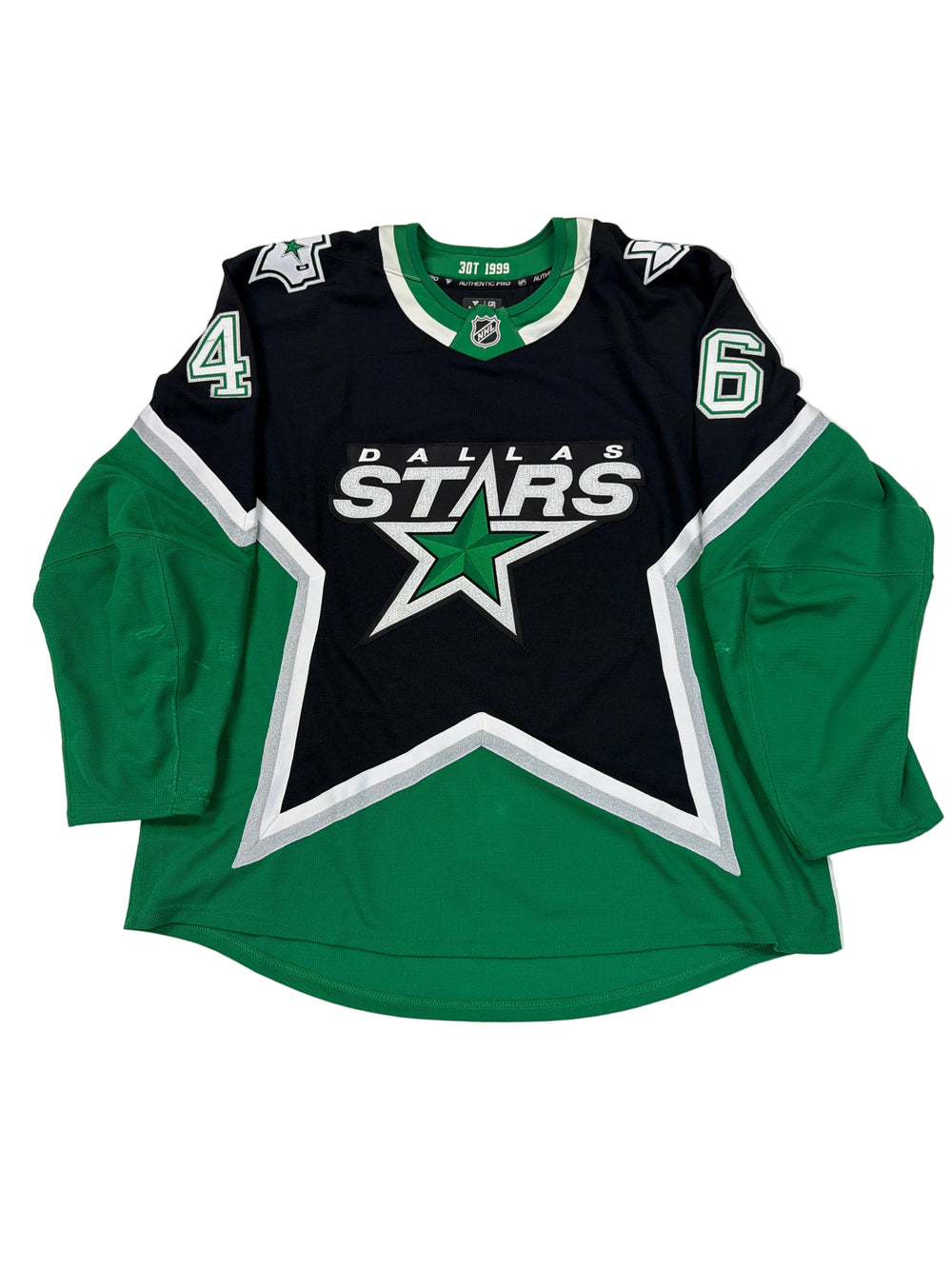 Green and black sports jersey with star logo on a white surface