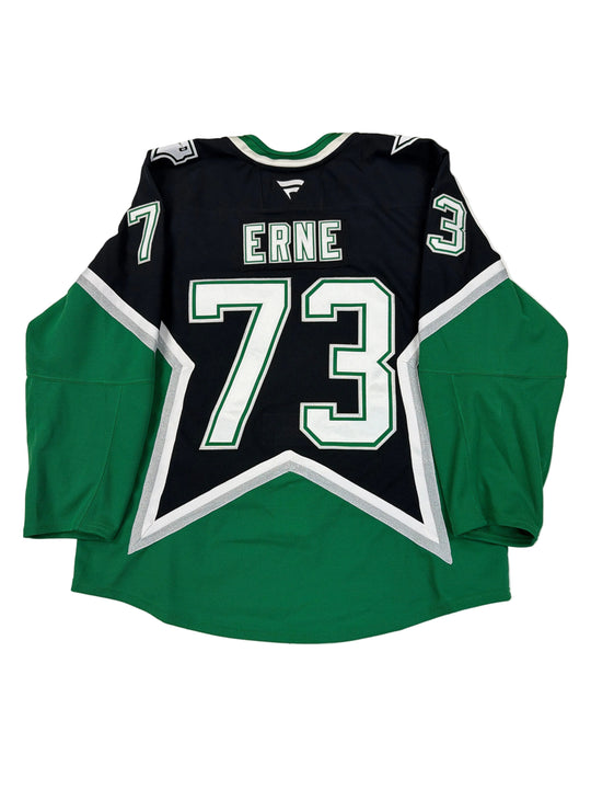 Green and black sports jersey with number 73 and name 'Erne' on a white surface.
