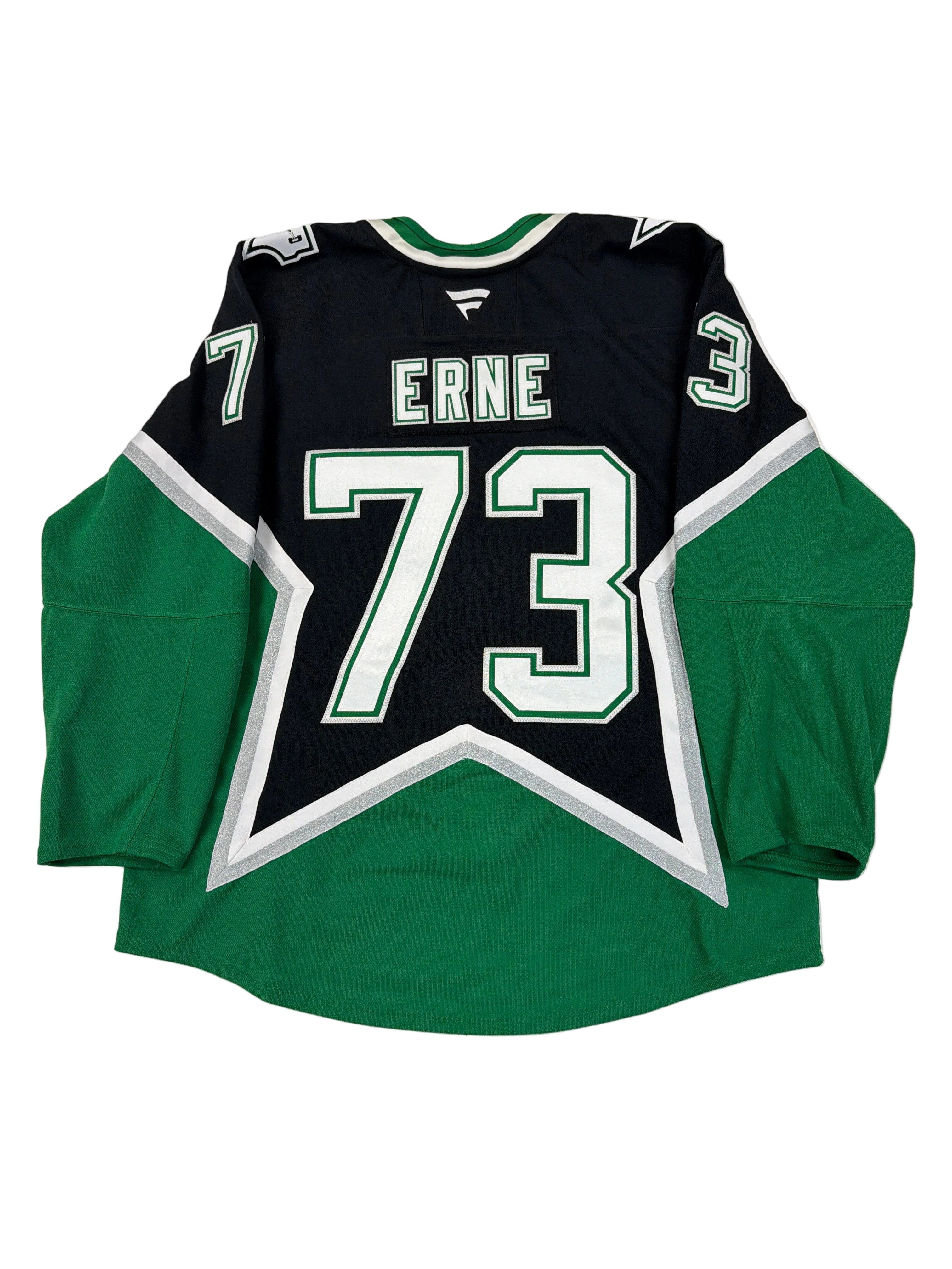 Green and black sports jersey with number 73 and name 'Erne' on a white surface.