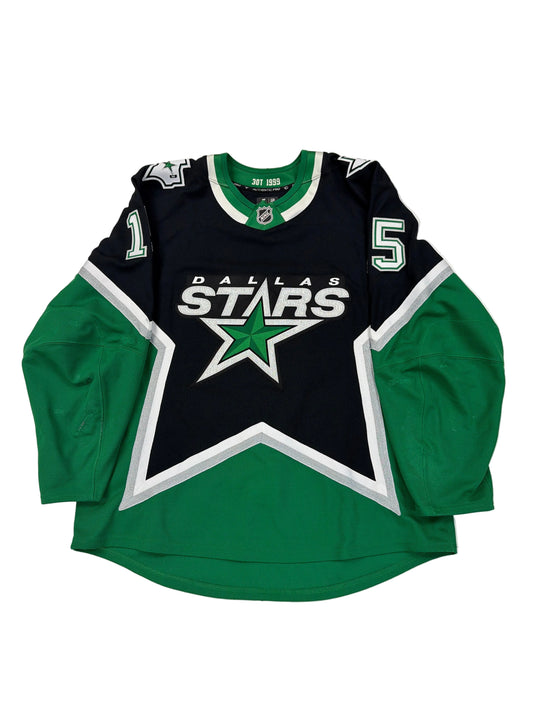 Green and black sports jersey with star logo on a white surface