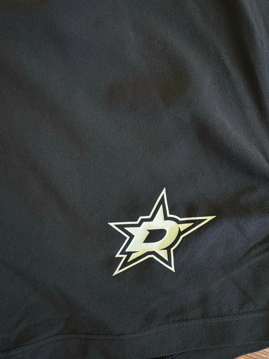 Close-up of a black fabric surface with a Dallas Stars logo patch in white