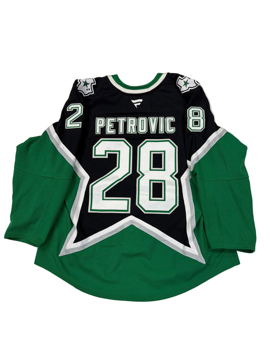 Green and black sports jersey with number 28 and name 'Petrovic' on a white surface.