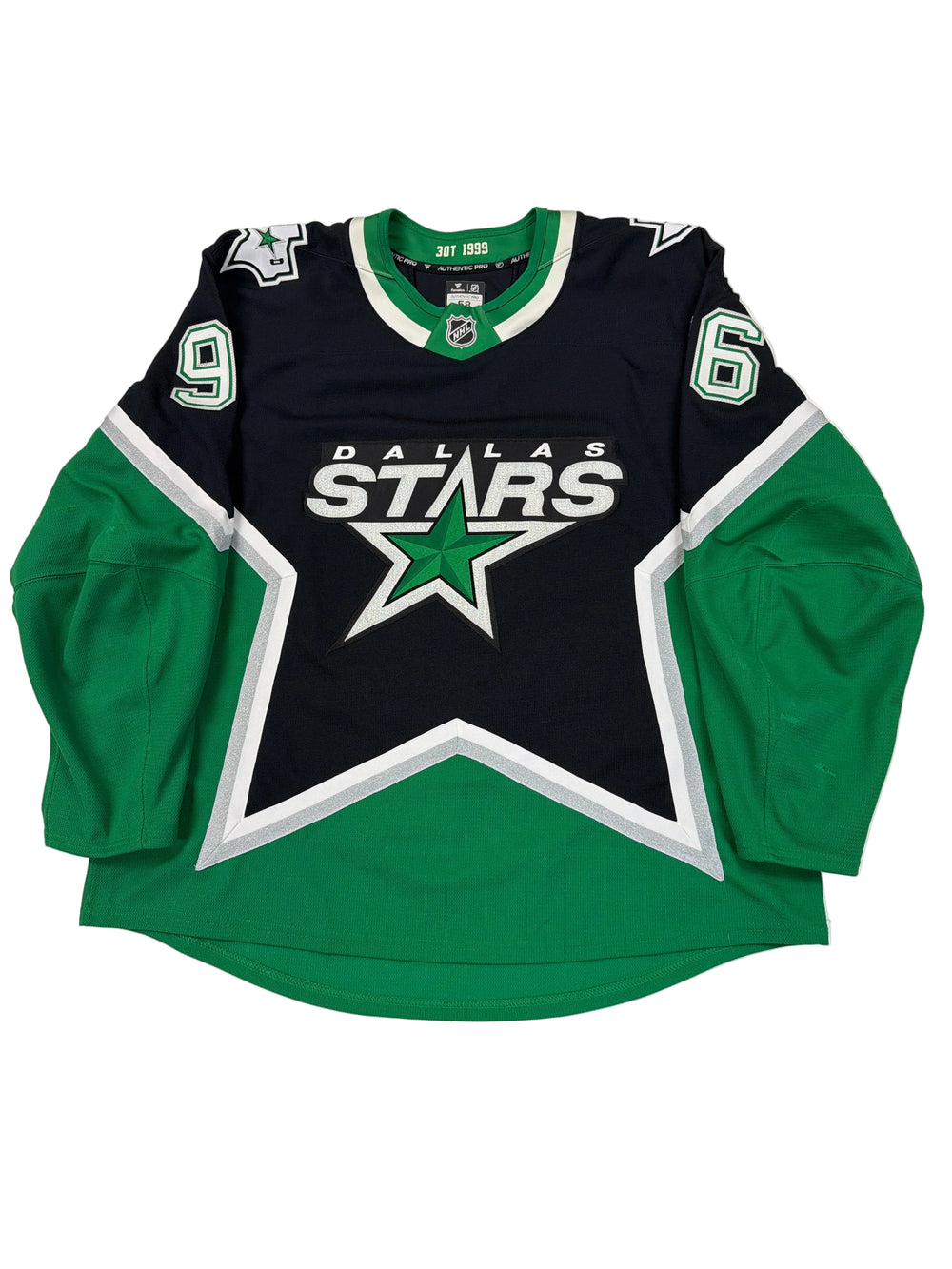 Green and black sports jersey with star logo on a white surface