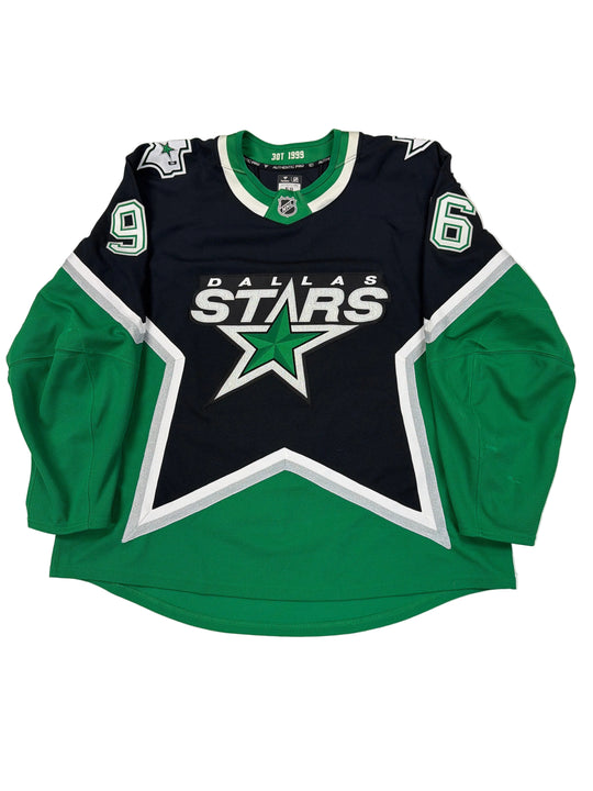 Green and black sports jersey with star logo on a white surface