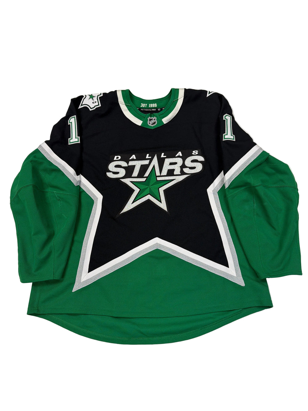 Green and black sports jersey with star logo on a white surface