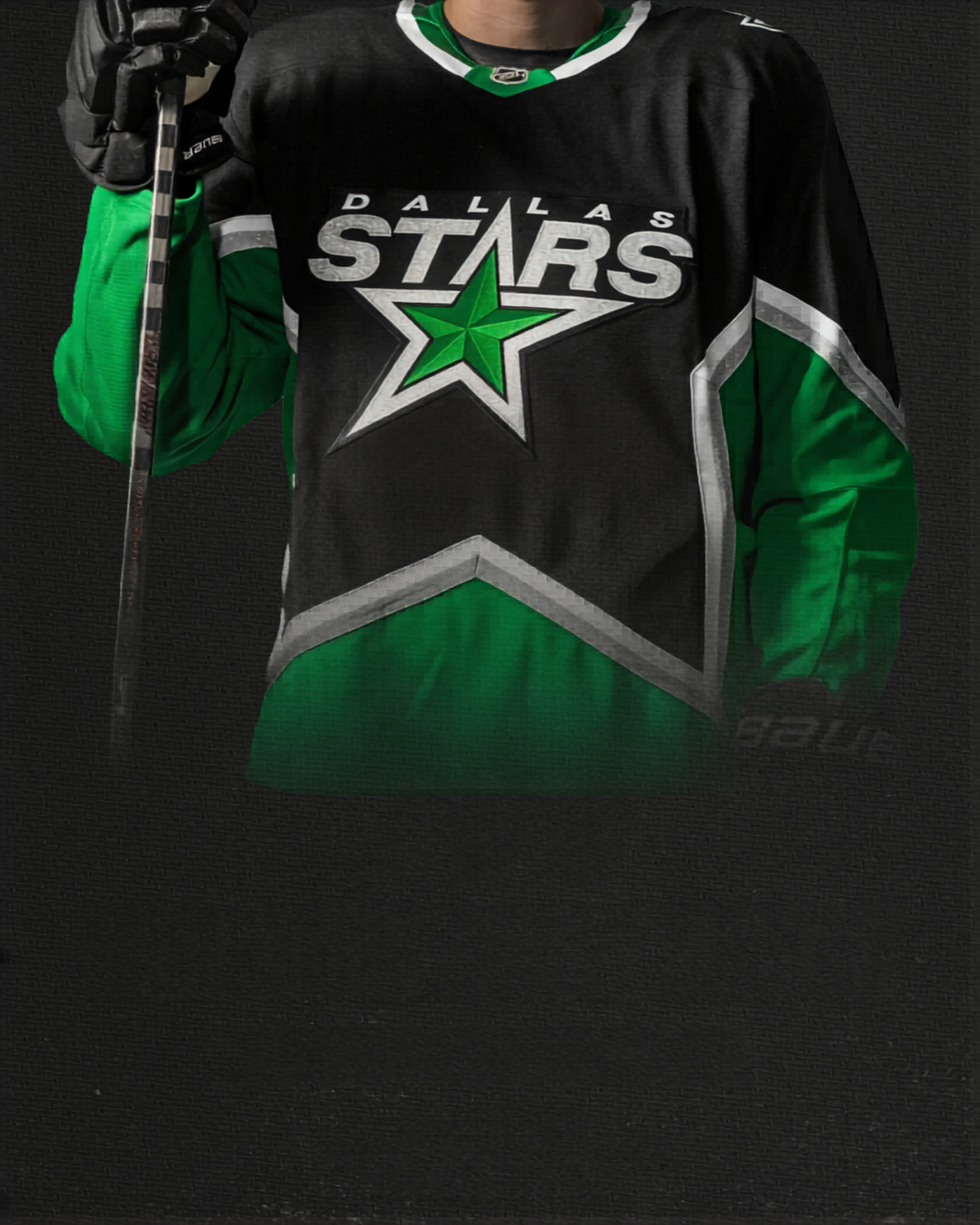 Person wearing a Dallas Stars hockey jersey holding a hockey stick on a dark background