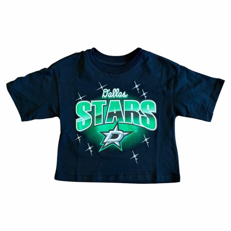 A black short-sleeve crop top t-shirt featuring a green and white Dallas Stars graphic on the front, displayed against a plain white background.