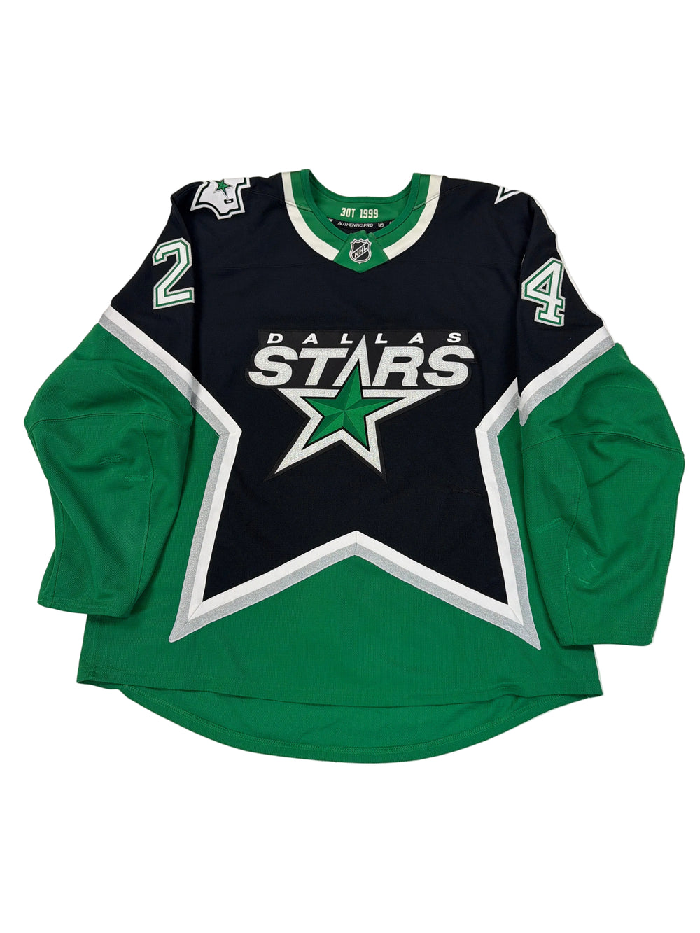 Green and black sports jersey with star logo on a white surface