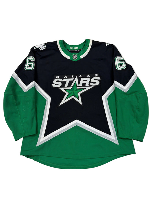 Green and black sports jersey with star logo on a white surface