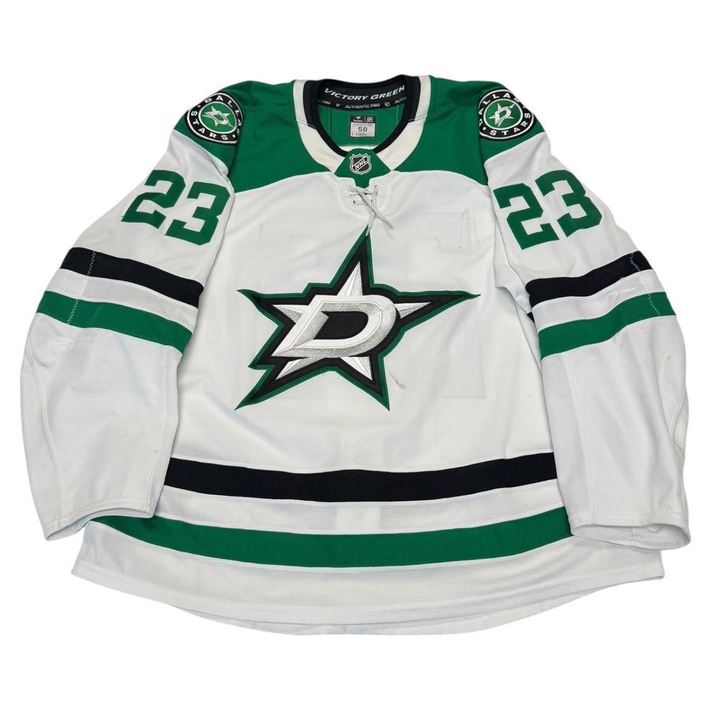 Game worn Dallas Stars Away jersey, number 23 on the sleeves with Dallas Stars logo on the chest. Hockey jersey on a white background
