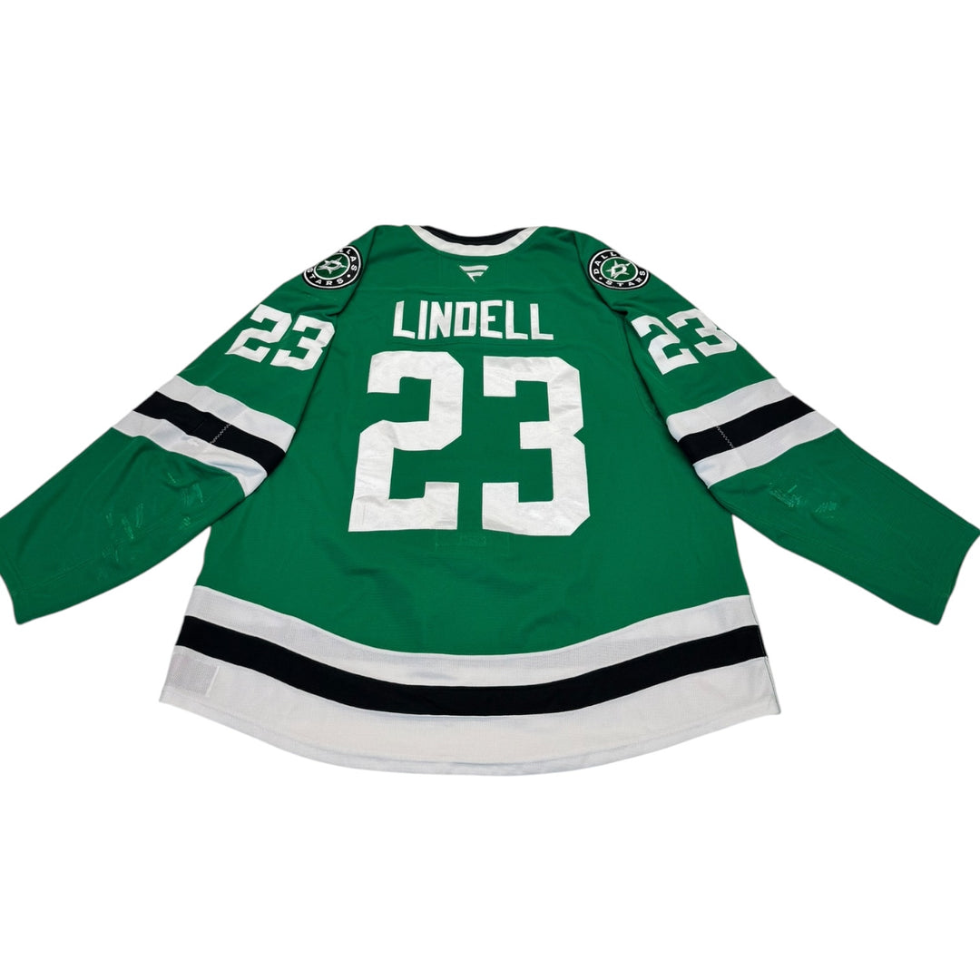 Game worn Dallas Stars home hockey jersey with number 23 and name 'Lindell' on a white background