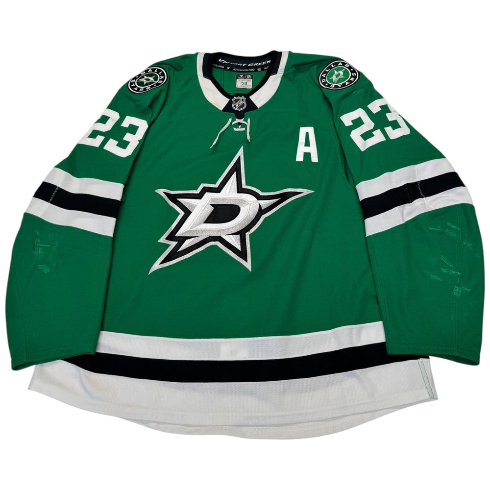 Green hockey jersey with star logo and number 23 on a white background