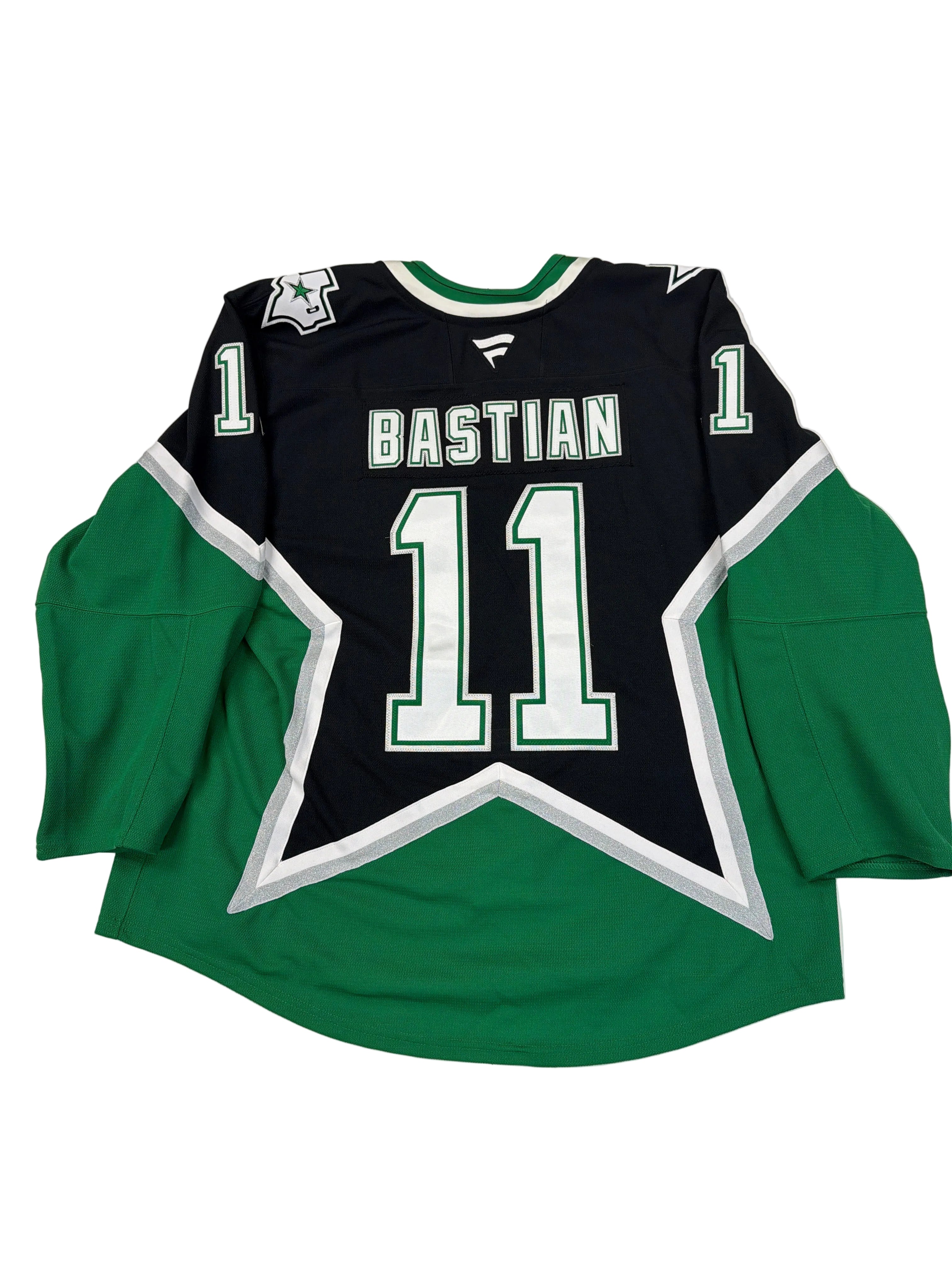 Green and black sports jersey with number 11 and name 'Bastian' on a white surface.