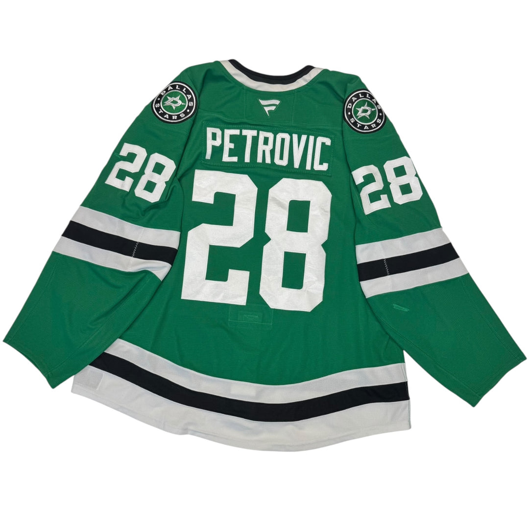 Game worn Dallas Stars home hockey jersey with number 28 and name Petrovic on a white background