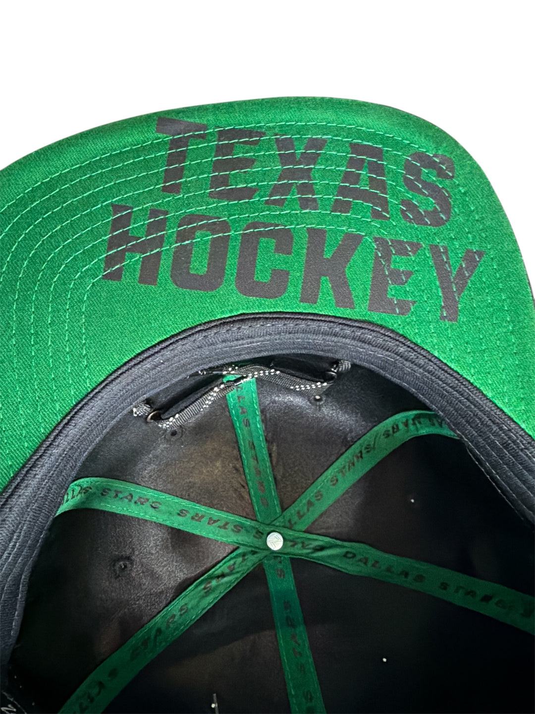 Green cap with 'Texas Hockey' text on a white background