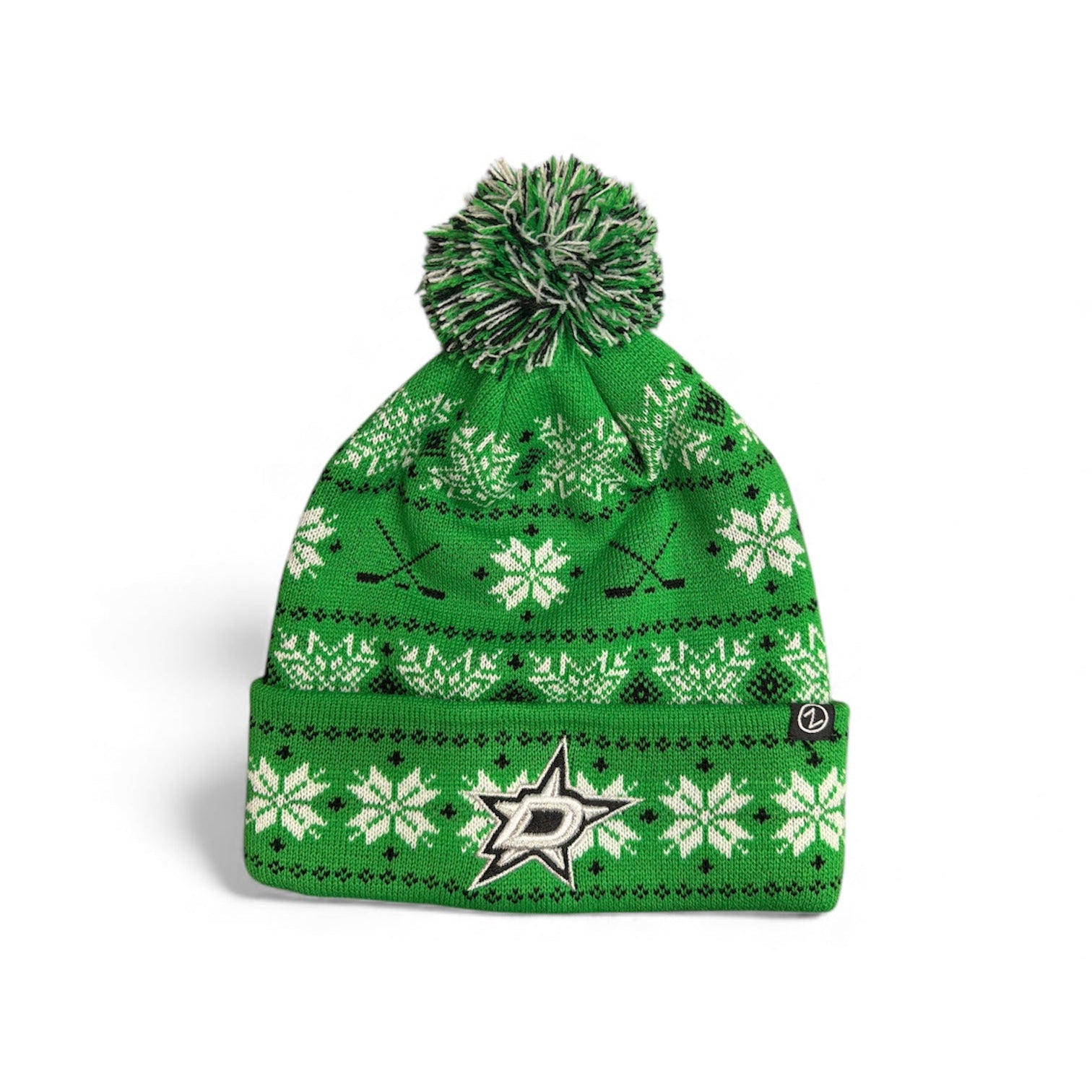 Green knit beanie with snowflake pattern and pom-pom on a white background