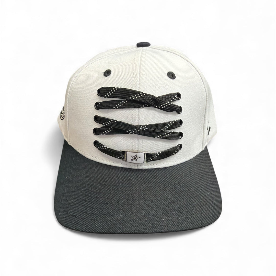Black and white cap with hockey lace design on a white background