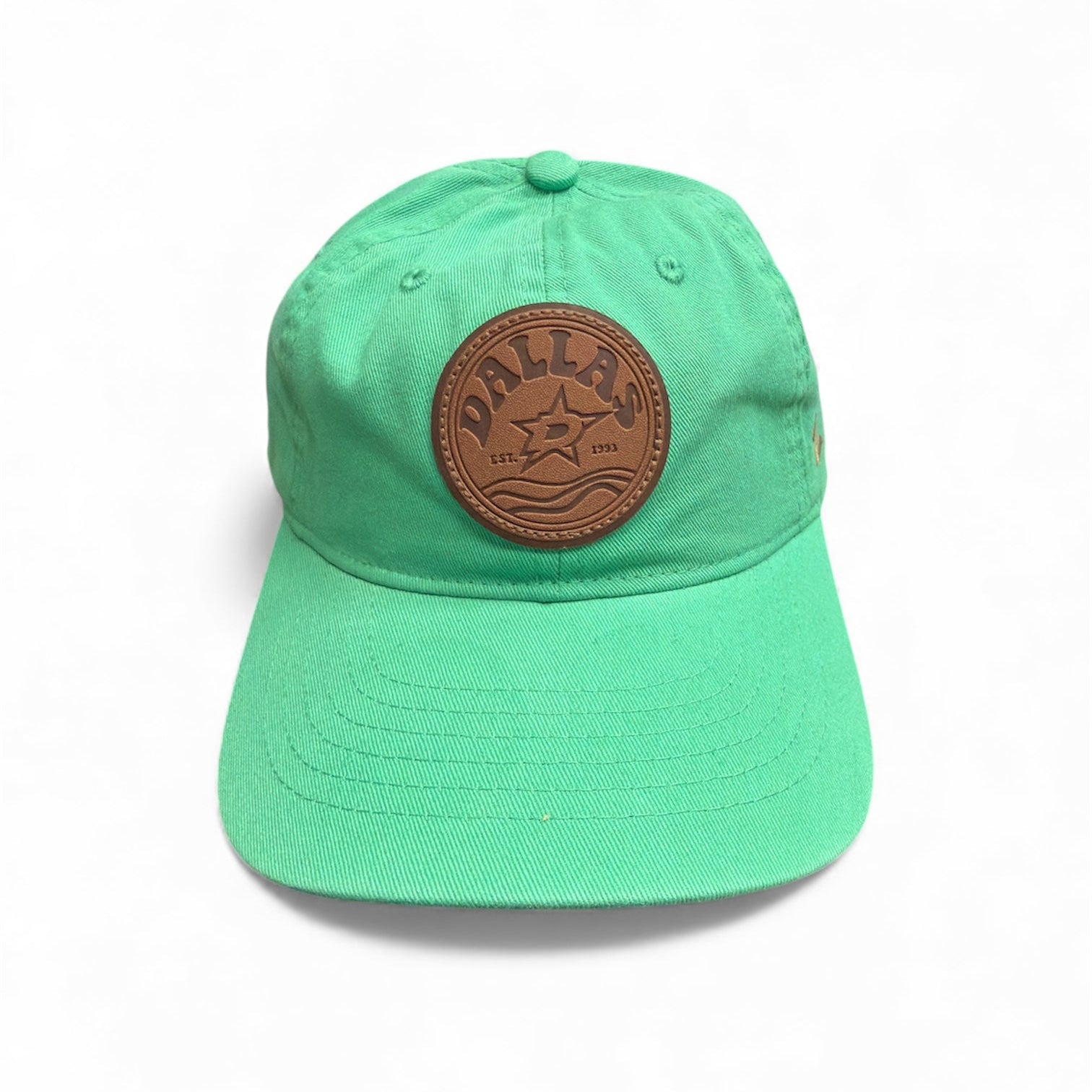 Green cap with a brown leather patch on a white background