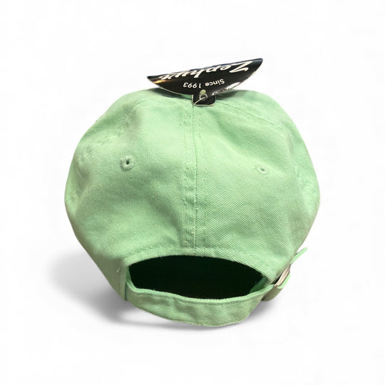 Light green cap with a brand tag on a white background