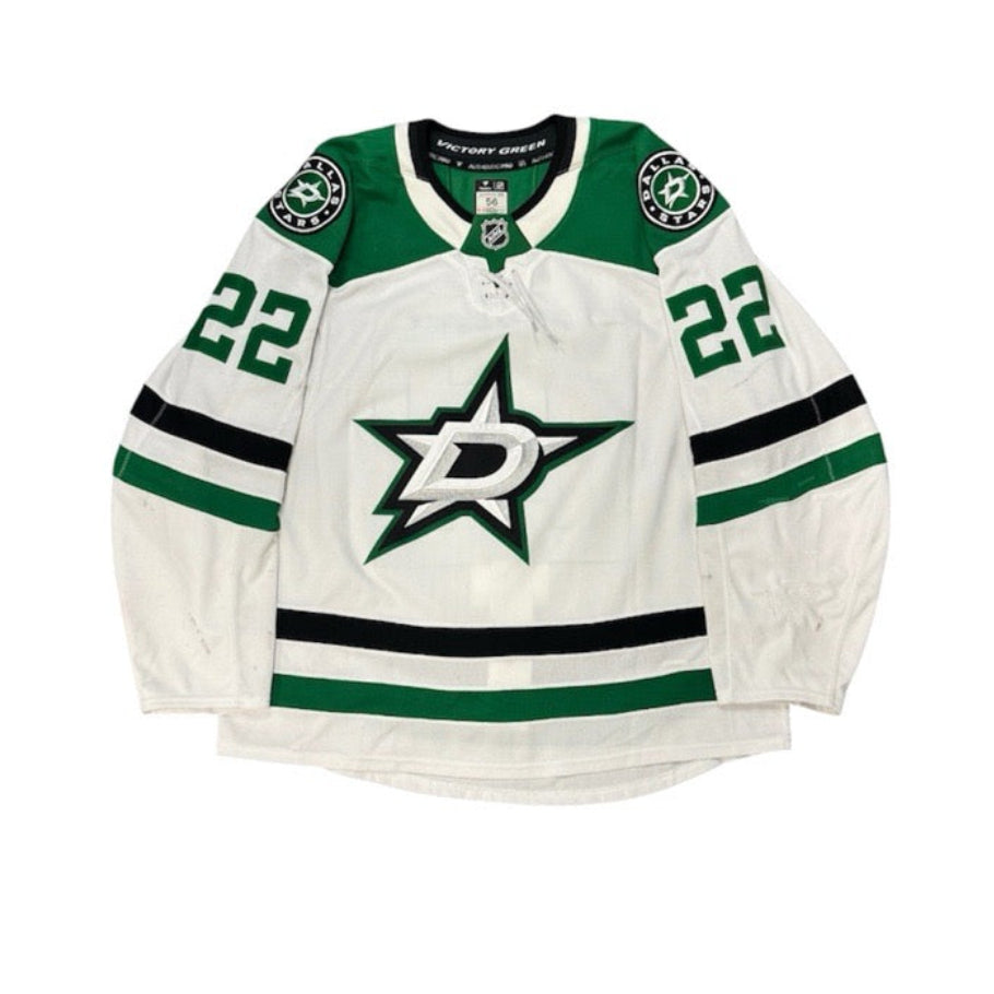 Game Worn Dallas Stars Away jersey with Stars logo on chest and number 22 on the sleeves. Jersey on a white background.