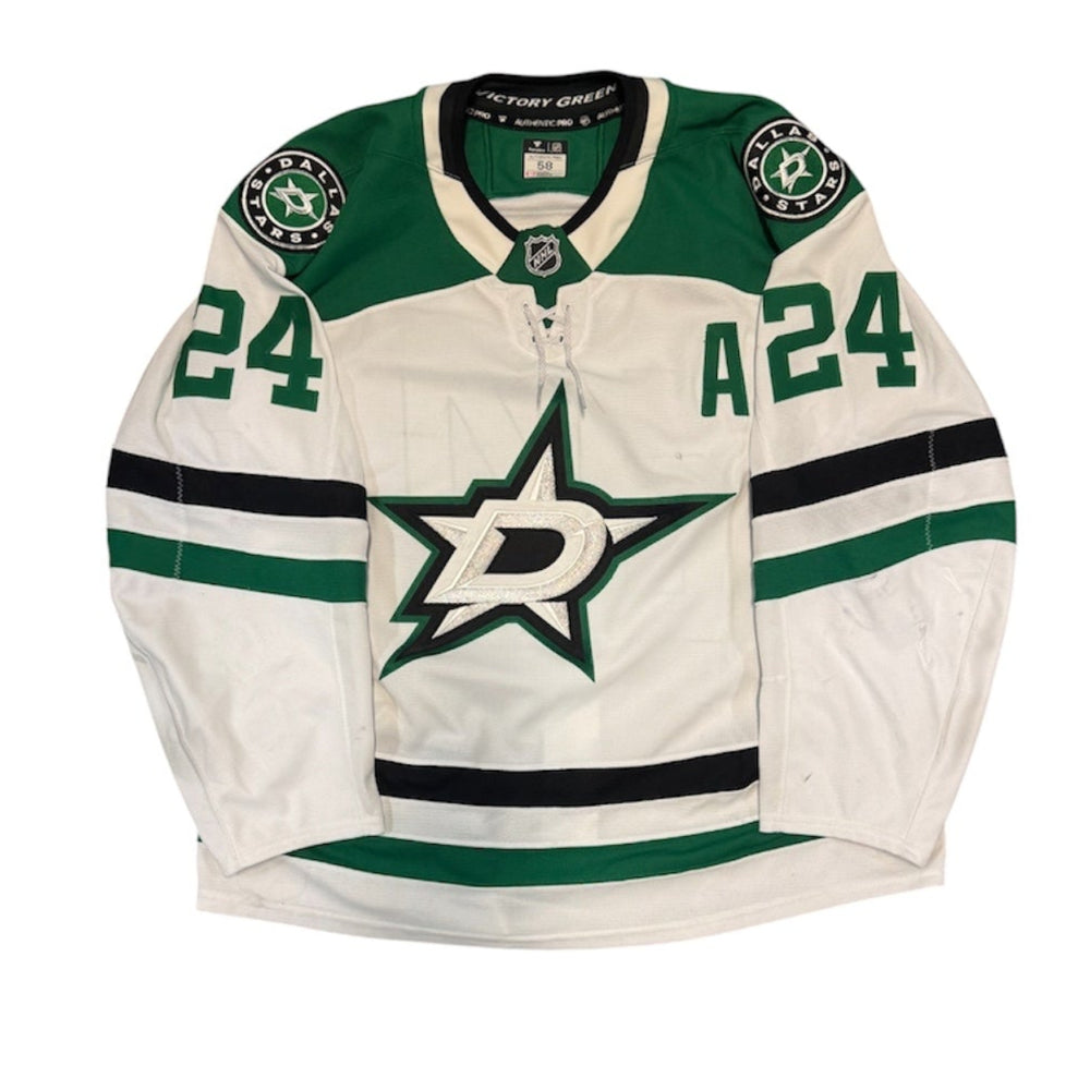Game Worn Dallas Stars Away jersey with Stars logo on chest and number 24 on the sleeves. Jersey on a white background.