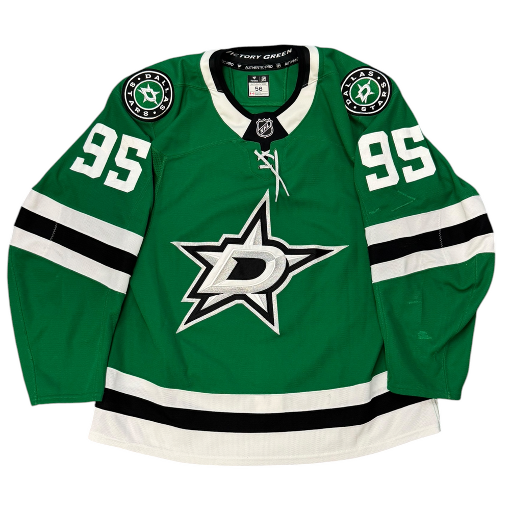 Game Worn Dallas Stars Home hockey jersey with number 95 on sleeves and Stars logo on chest with a white background