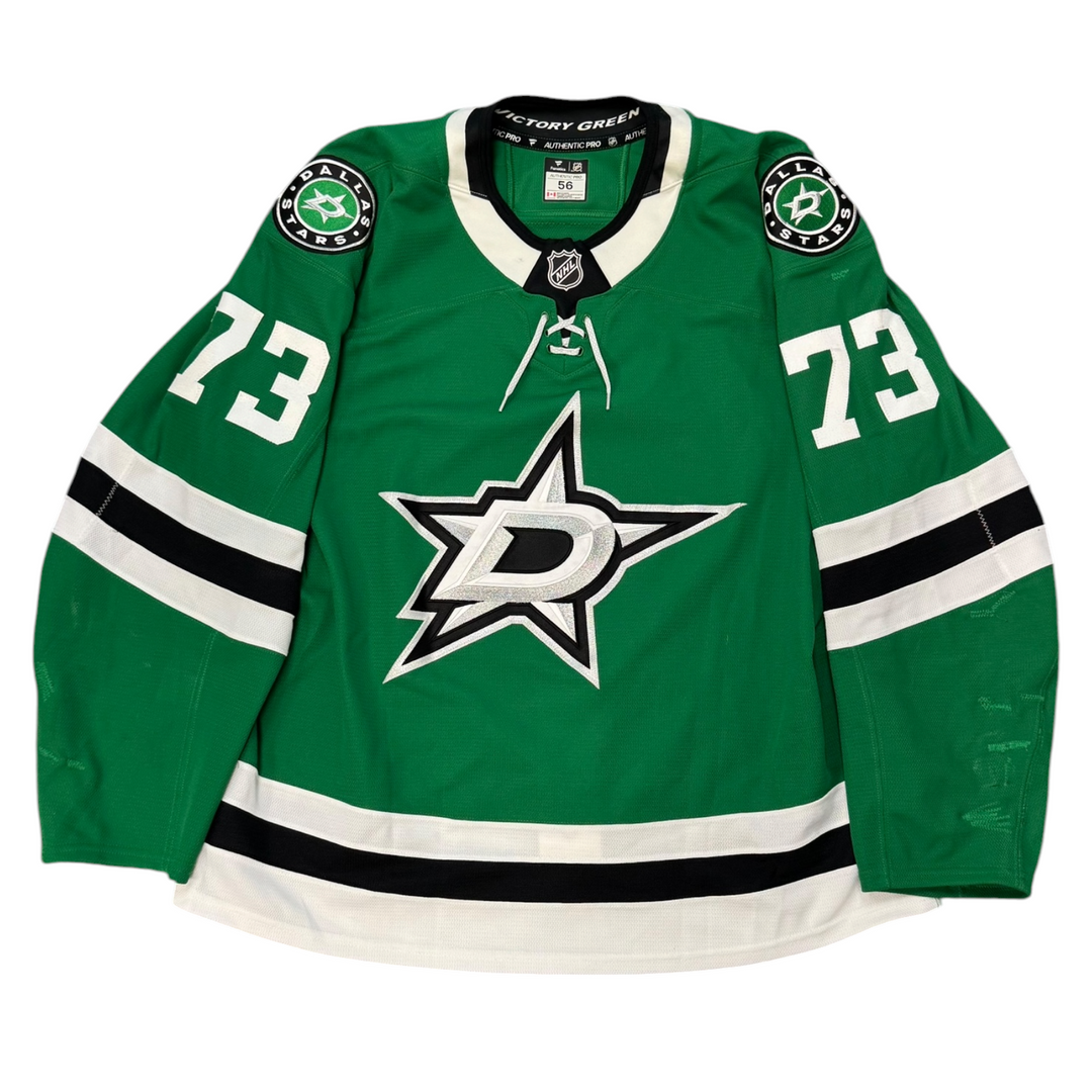 Game Worn Dallas Stars Home hockey jersey with number 73 on sleeves and Stars logo on chest with a white background