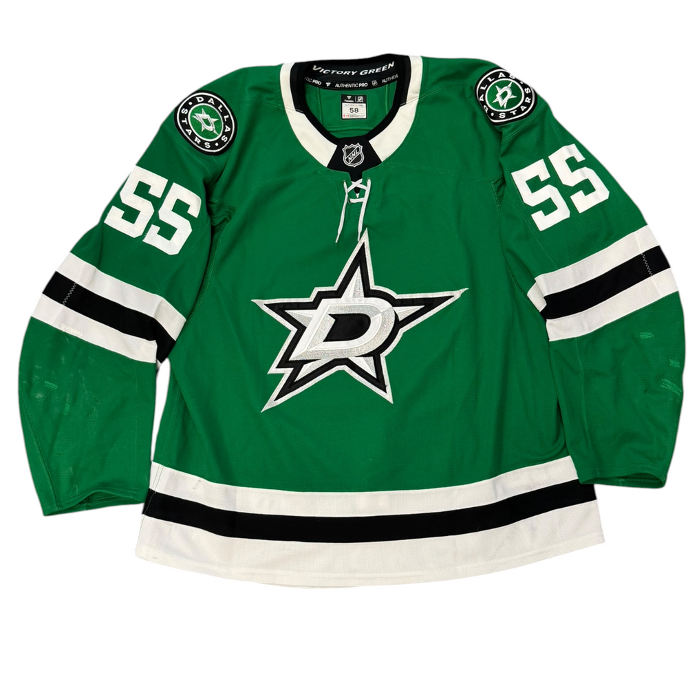 Game Worn Dallas Stars Home hockey jersey with number 55 on sleeves and Stars logo on chest with a white background