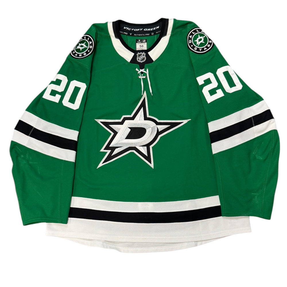 Game Worn Dallas Stars Home hockey jersey with number 20 on sleeves and Stars logo on chest with a white background
