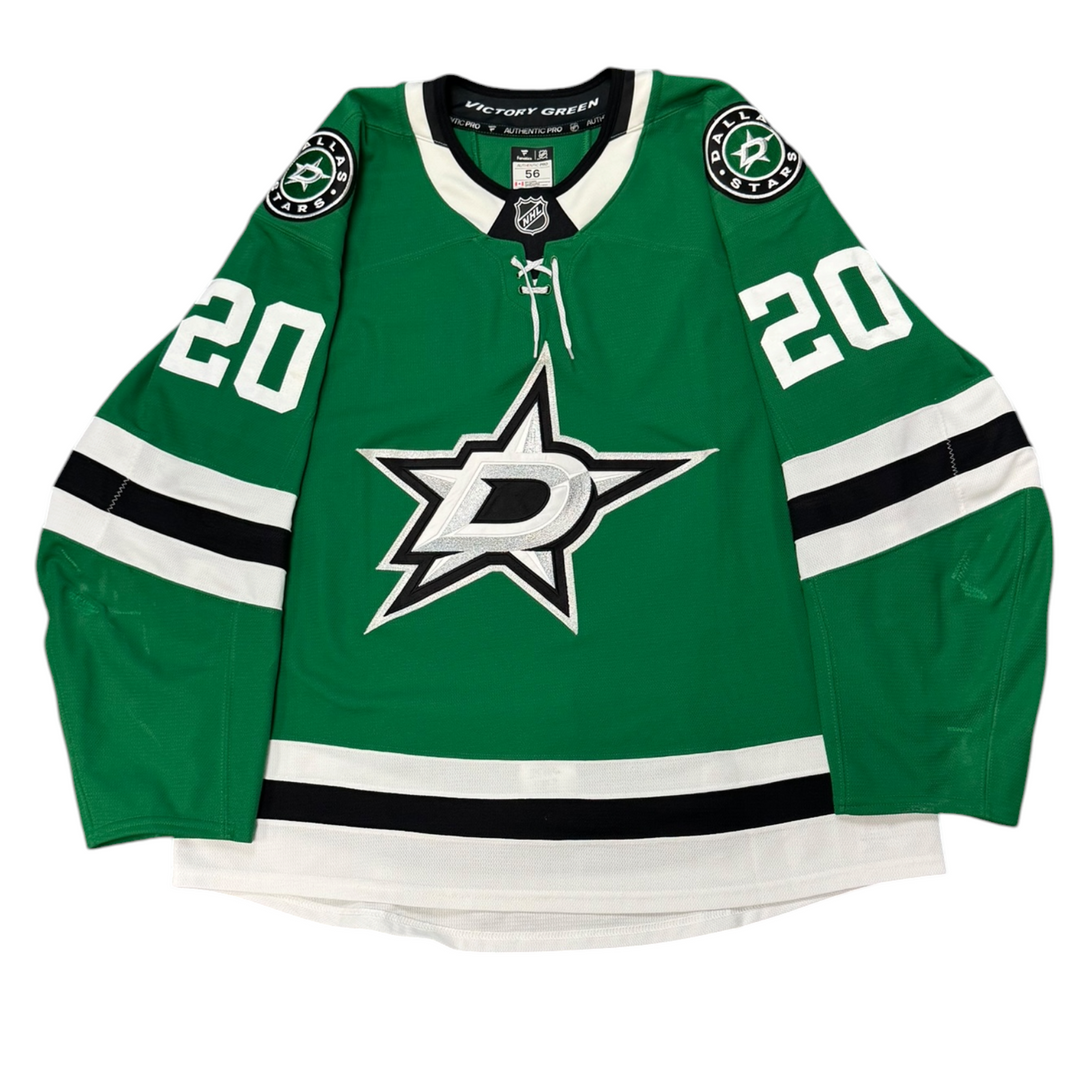 Game Worn Dallas Stars Home hockey jersey with number 20 on sleeves and Stars logo on chest with a white background