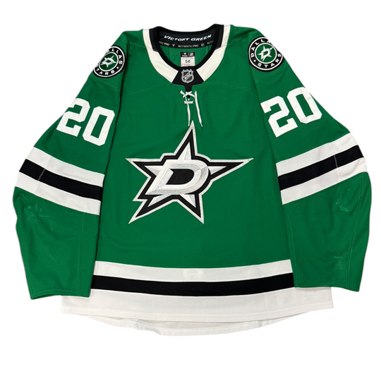 Game Worn Dallas Stars Home hockey jersey with number 20 on sleeves and Stars logo on chest with a white background