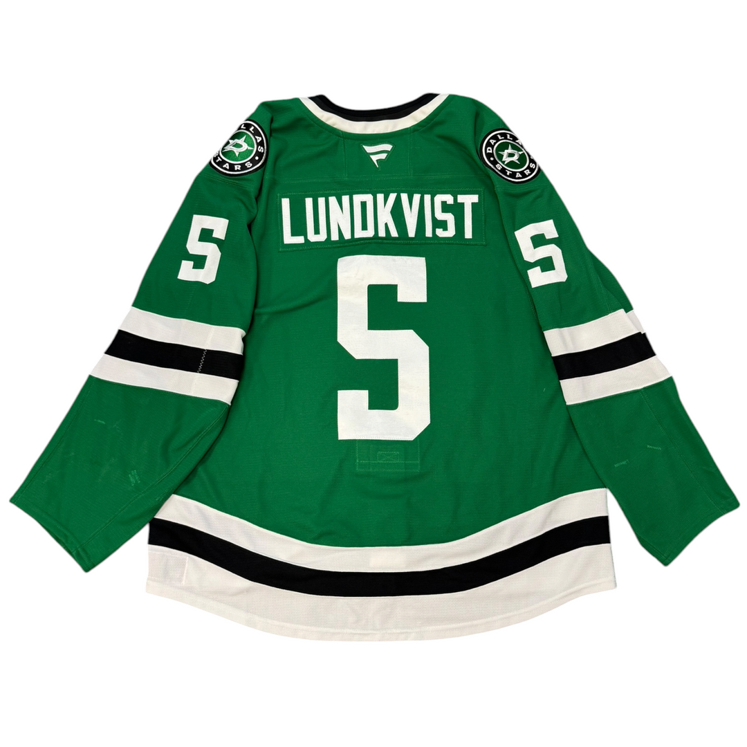 Game Worn Dallas Stars Home hockey jersey with number 5 and name 'Lundkvist' on a white background