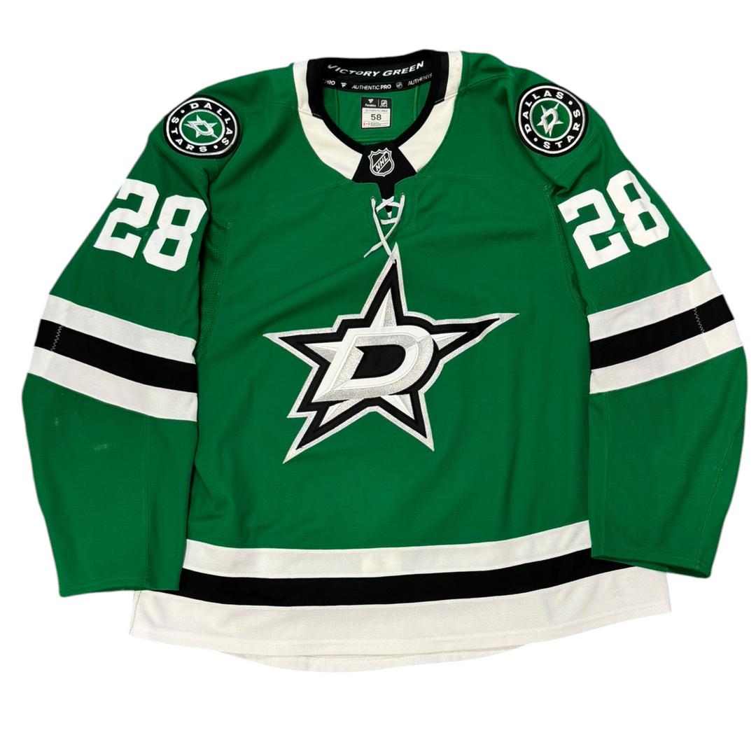 Game Worn Dallas Stars Home hockey jersey with number 28 on sleeves and Stars logo on chest with a white background
