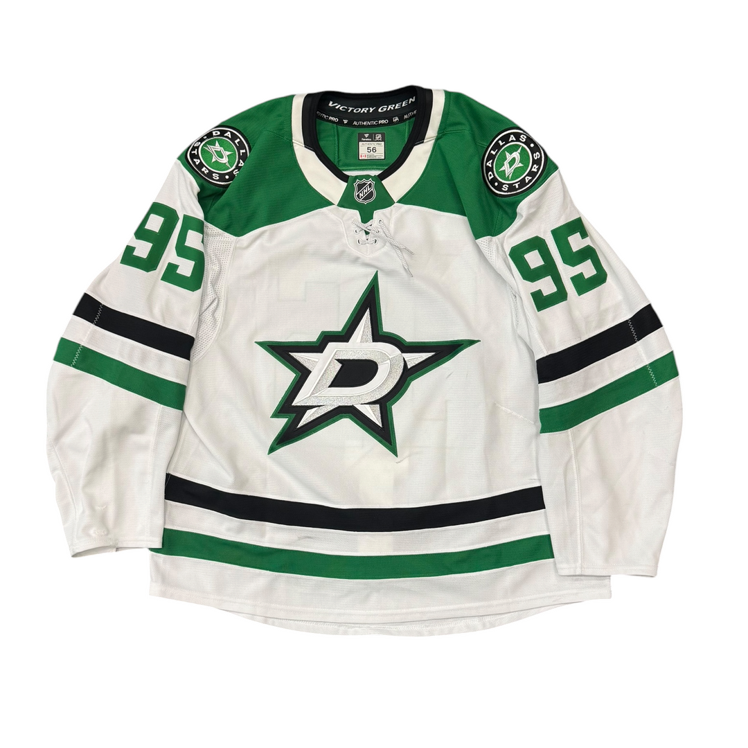 Game Worn Dallas Stars Away hockey jersey with number 95 on sleeves and Stars logo on chest with a white background