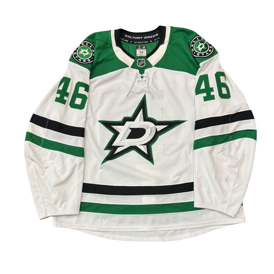 Game Worn Dallas Stars Away hockey jersey with number 46 on sleeves and Stars logo on chest with a white background