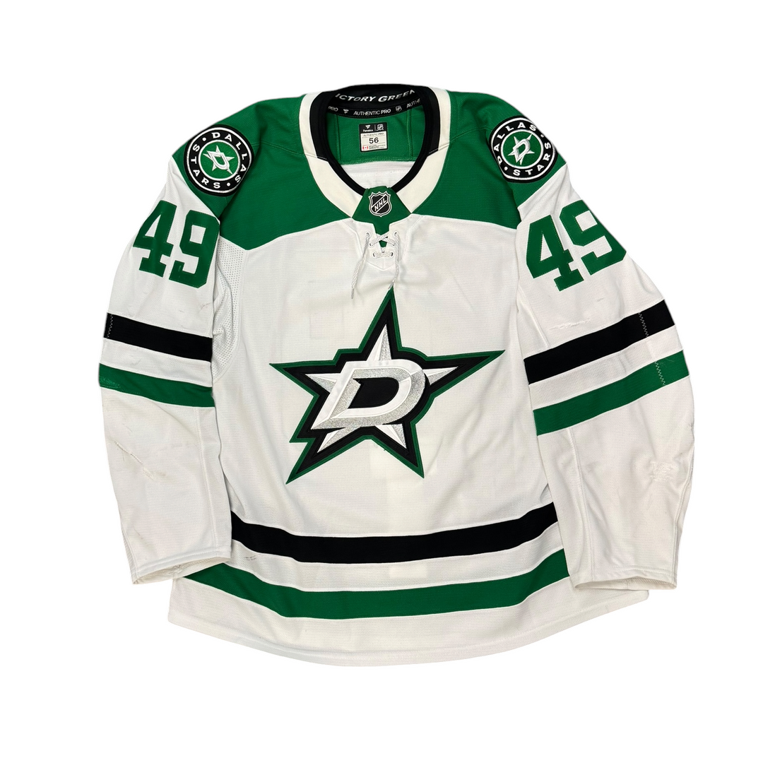 Game Worn Dallas Stars Away jersey with Stars logo on chest and number 49 on the sleeves. Jersey on a white background.