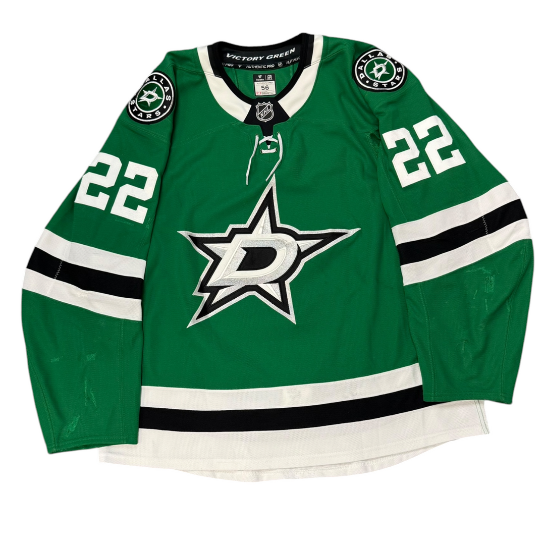 Game Worn Dallas Stars Home hockey jersey with number 22 on sleeves and Stars logo on chest with a white background