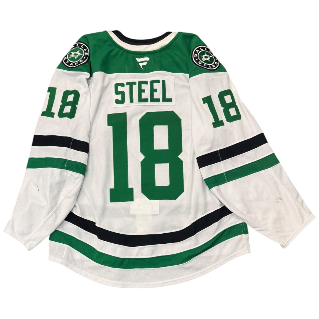 Game worn Dallas Stars Away jersey with number 18 and name 'Steel'. jersey on a white background